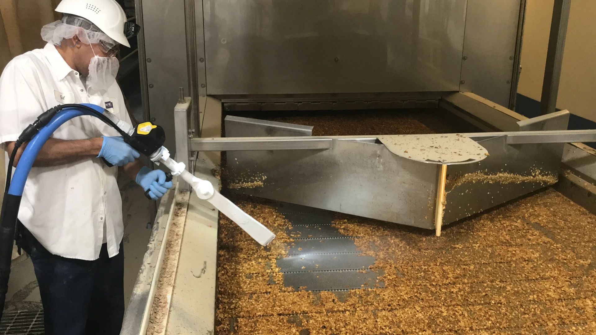 Norco technician dry ice blasting a food production oven and conveyor